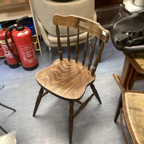 Antique stickback dining chair with a shaped seat and wooden construction.