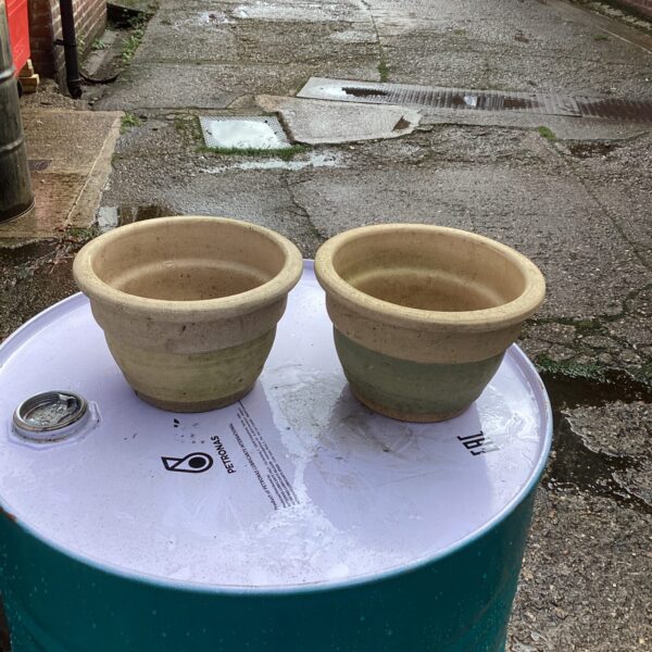 Two small terracotta garden pots for outdoor plants.