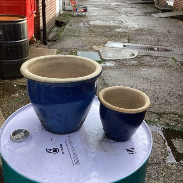 Pair of weathered glazed garden pots for outdoor plants.