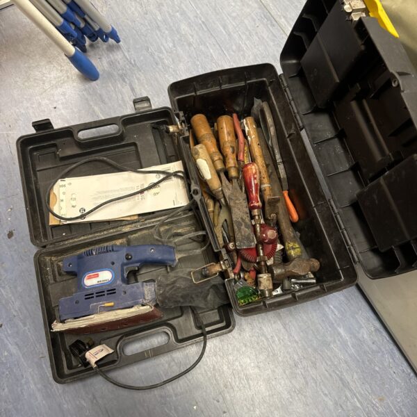 Vintage Challenge sander in a Stanley toolbox with assorted tools.