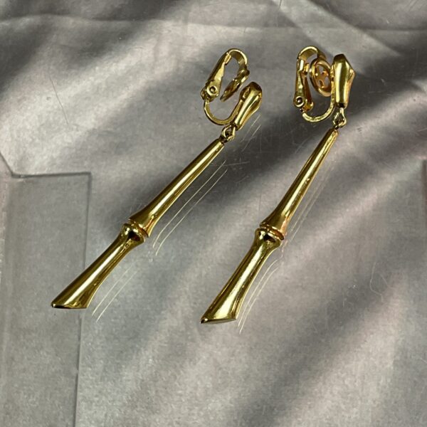 Vintage Trifarri drop earrings in gold tone, side view.