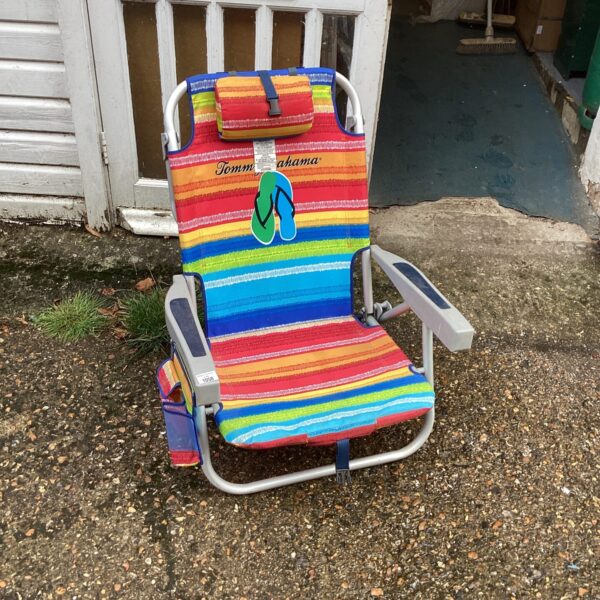 Colourful striped beach chair for outdoor relaxation.