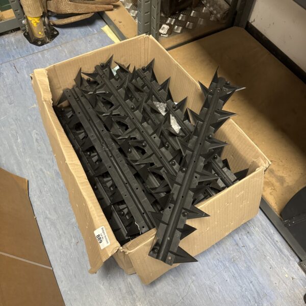 Plastic cat fence guards for deterring cats from fences.