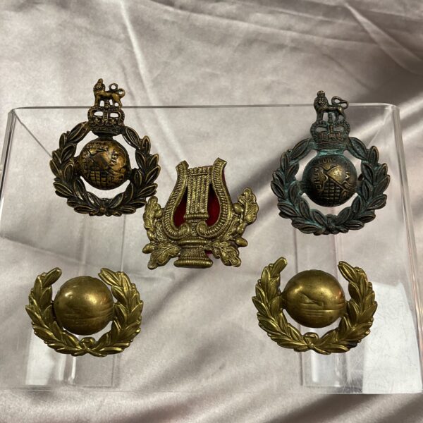Royal Marines badges collection, including cap, collar, and musician insignia.