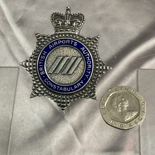 Silver British Airports Authority Constabulary cap badge, detailed design.