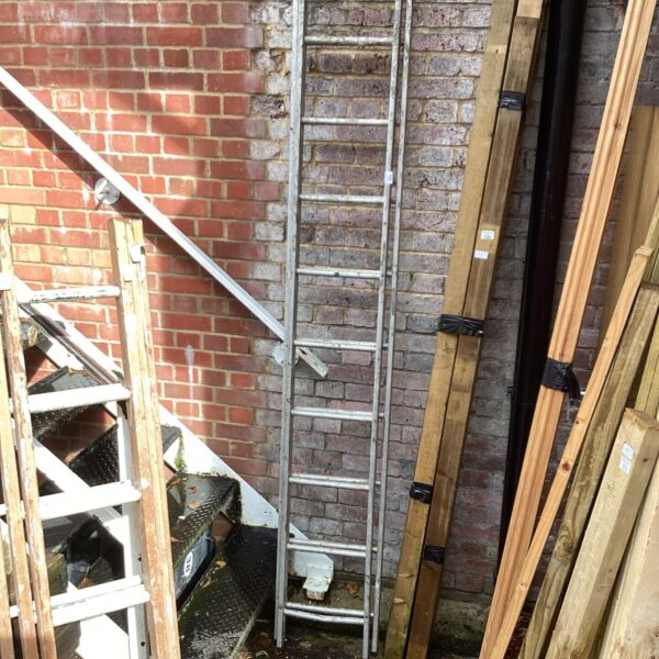 Used two-piece aluminium extending ladder leaning against a brick wall.