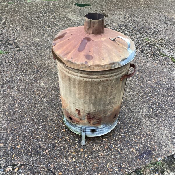 Rusty vintage garden incinerator for outdoor waste disposal.