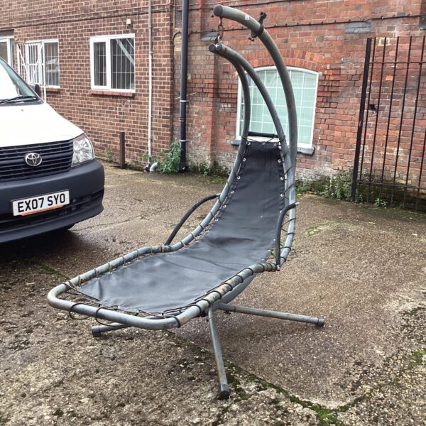 Metal garden banana lounger chair in outdoor setting.