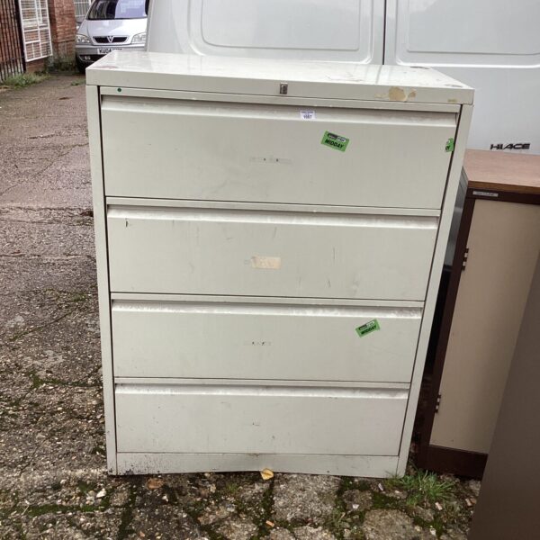 Vintage metal filing cabinet with four drawers for office storage.