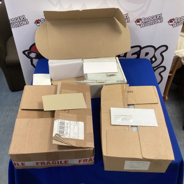 Three boxes of assorted envelopes, including windowed and branded options.