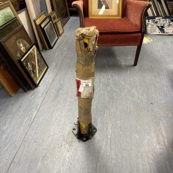 New retractable security bollard with keys for property protection.