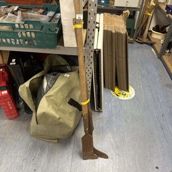 Pair of vintage scythes with wooden handles and curved blades.