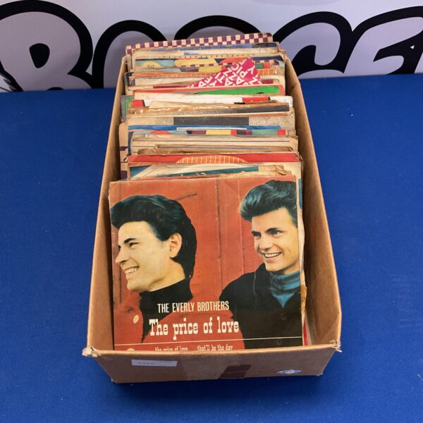 Vintage lot of 7 inch vinyl records in a cardboard box.