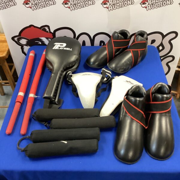 Karate training equipment lot with punch pads and nunchucks.