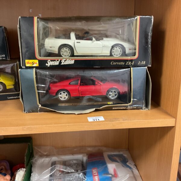 Diecast model cars featuring a Corvette ZR-1 and Ferrari 348 TS.