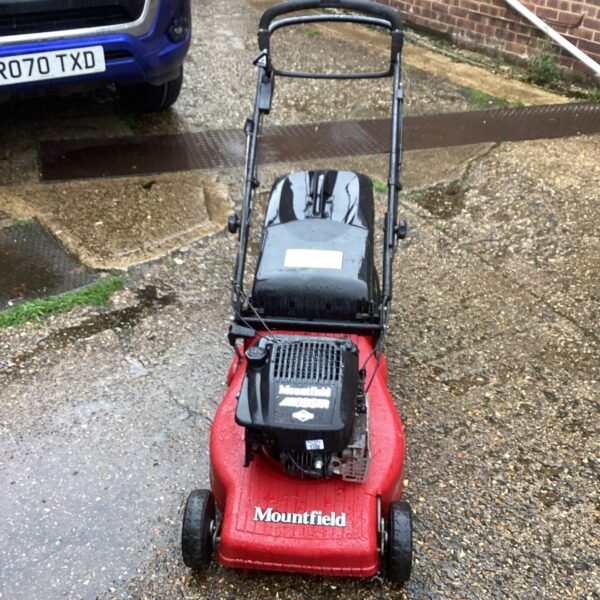 Red Mountfield 480 petrol lawn mower in a garden setting.