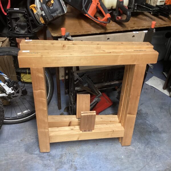 Pair of rustic wooden trestles for workshop support.