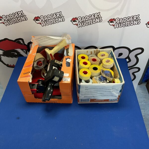 Box of vintage pricing guns and price gun tapes for retail use.