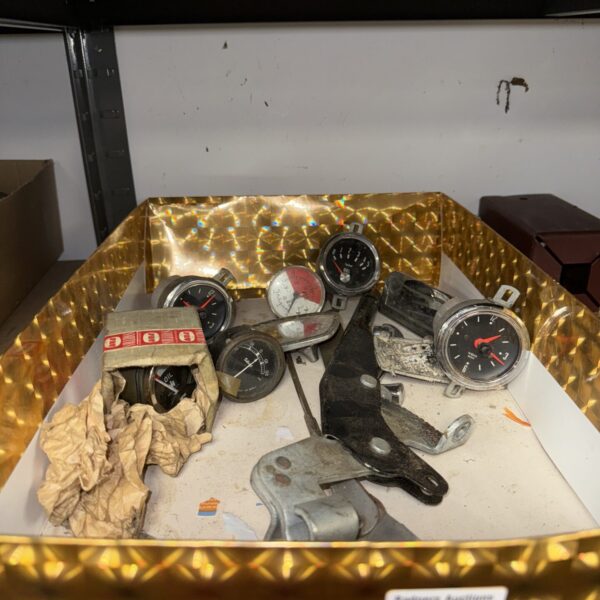 Vintage motoring gauges in a lot, classic car instruments.
