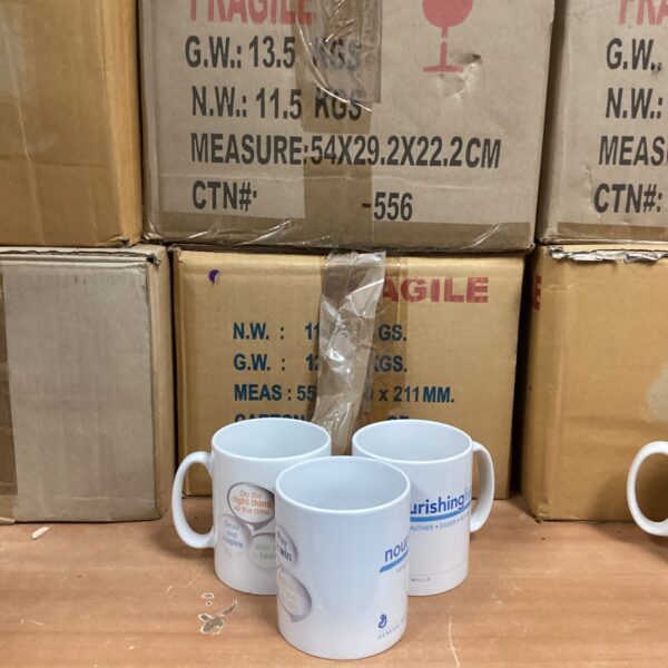 Bulk lot of Nourishing Lives branded ceramic mugs for catering.