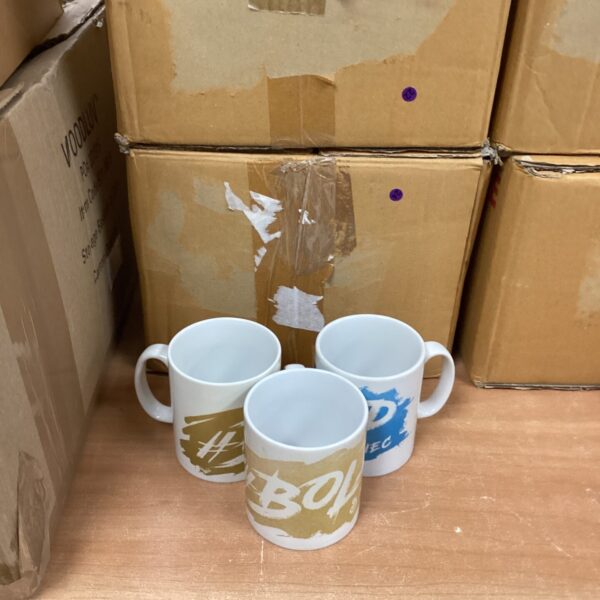 Stack of branded mugs including Bold and NEC logos.