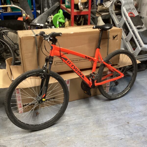 Used B Twin mountain bike in used condition, ideal for outdoor cycling.