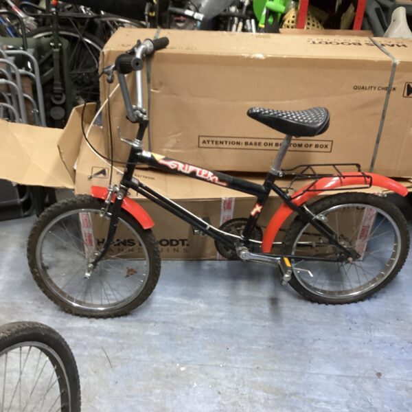 Red vintage Raleigh Grifter bicycle, classic 1980s design.