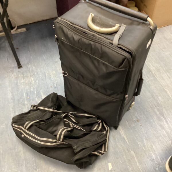 Black wheeled suitcase and holdall travel set.