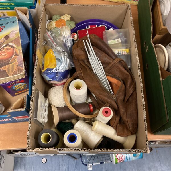 Vintage sewing and knitting lot with colourful threads and needles.
