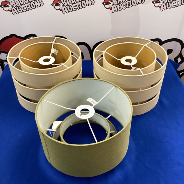 Three vintage lamp shades in a neutral colour.