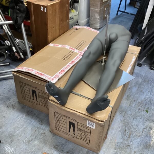 Boxed Hans Boodt trouser mannequins for retail display.