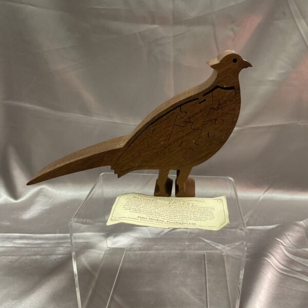 Detailed wooden Peter Storen pheasant puzzle, a collectible folk art piece.