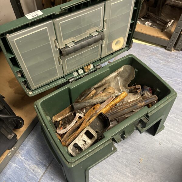 Vintage green metal toolbox filled with various hand tools.