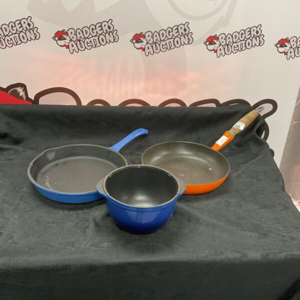 Lot of three vintage Le Creuset enamel pans for cooking.