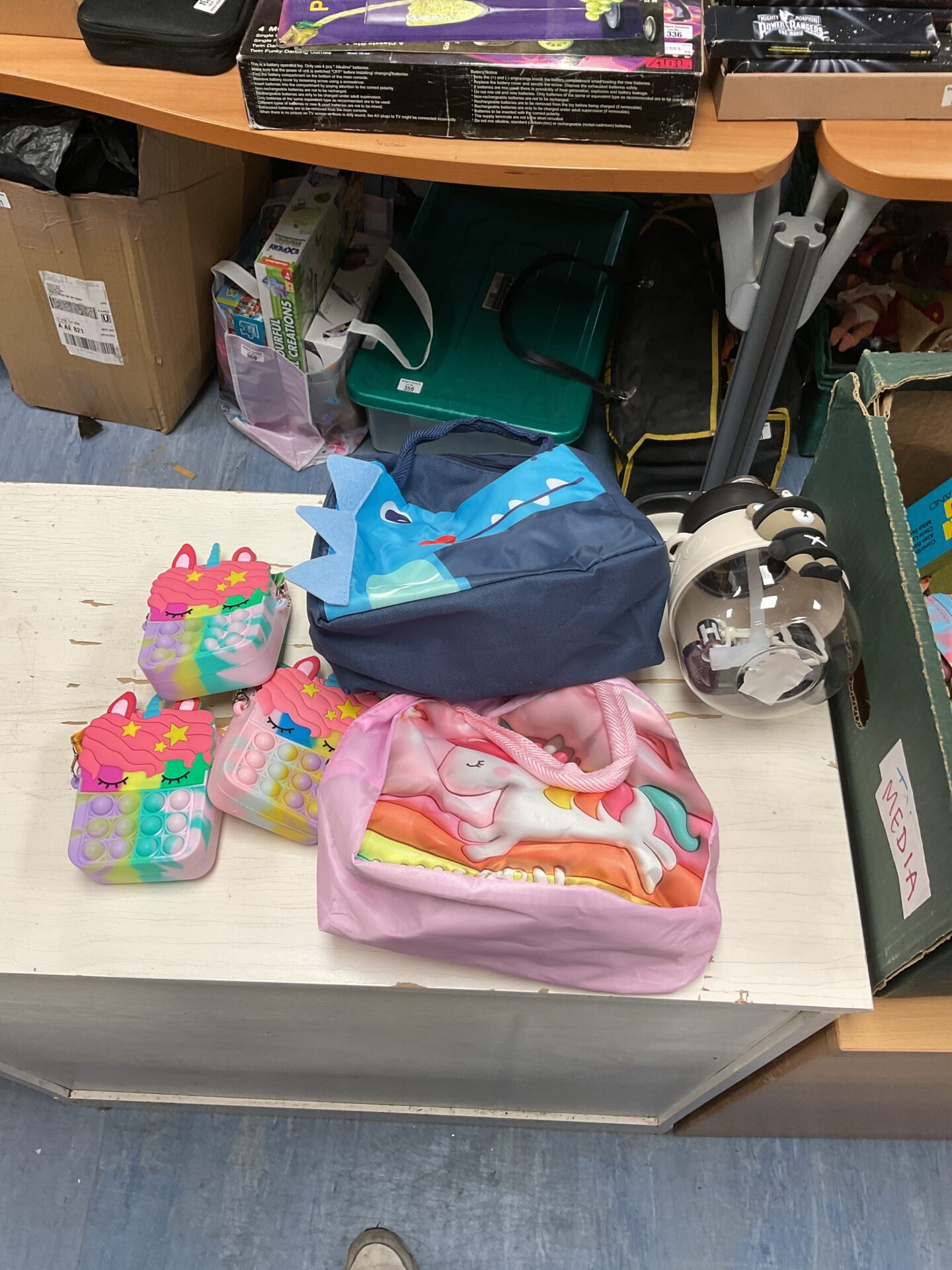 469 Box of mixed kids items including bags and a flash bear flask