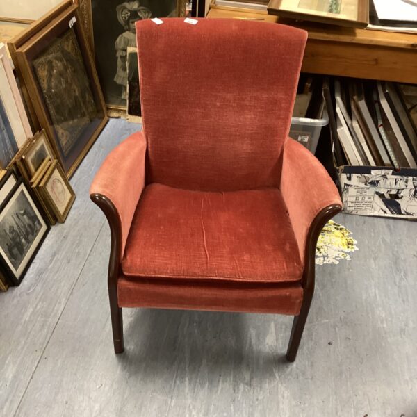 Terracotta vintage nursery chair with curved back and arms.