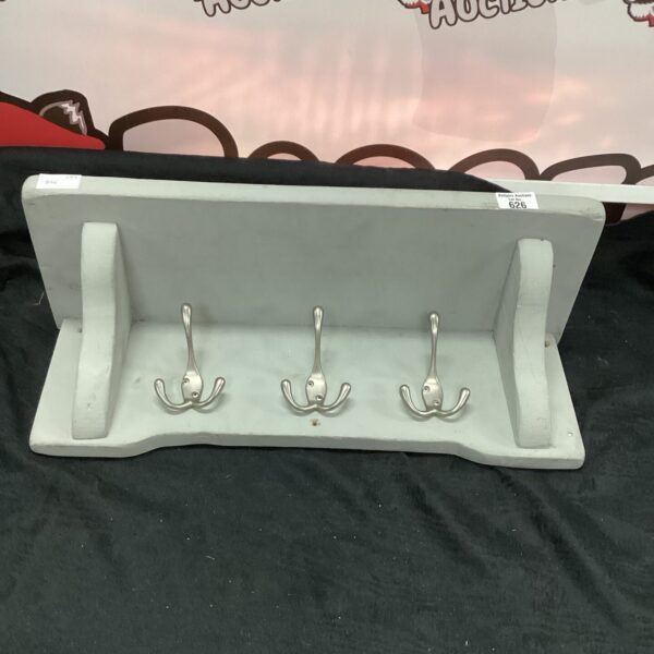 Vintage wooden coat rack with shelf and hooks for hallway storage.