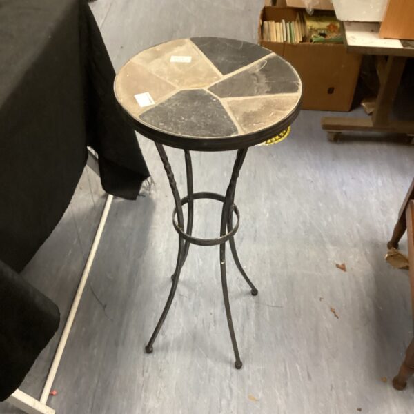 Colourful tile top ornamental table with wrought iron legs.