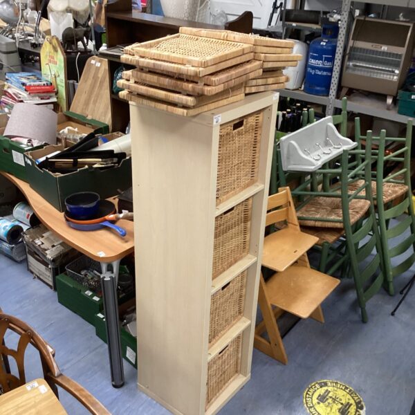 Tall raffia storage unit with multiple woven boxes.