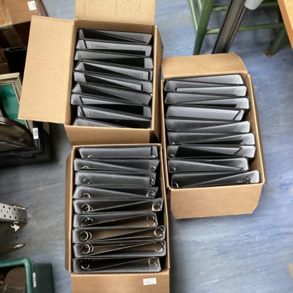 Three boxes of ring binders for document organization.