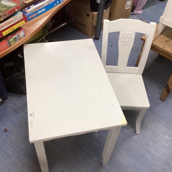 White child's table and chair set for playroom use.