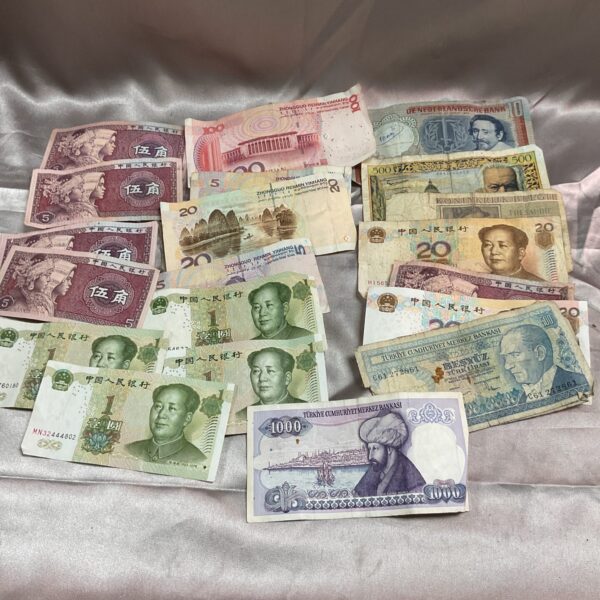 Collection of diverse overseas bank notes and foreign currency.
