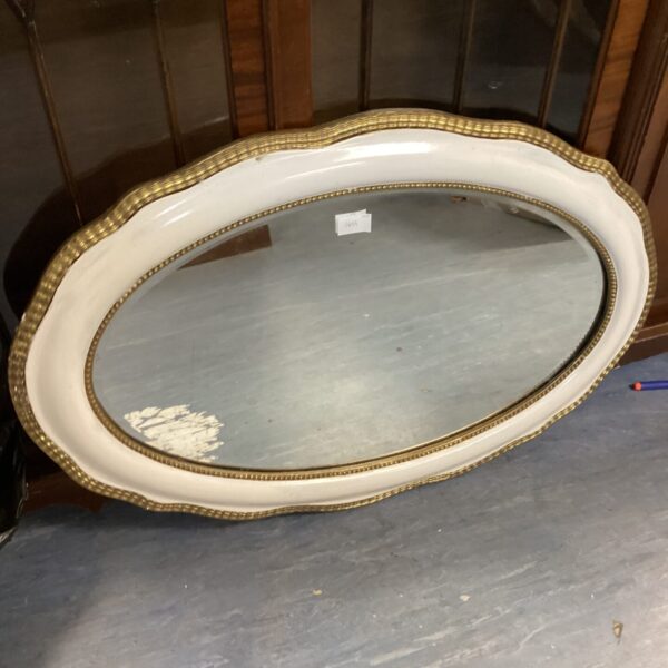 Vintage white painted oval mirror for wall decor.