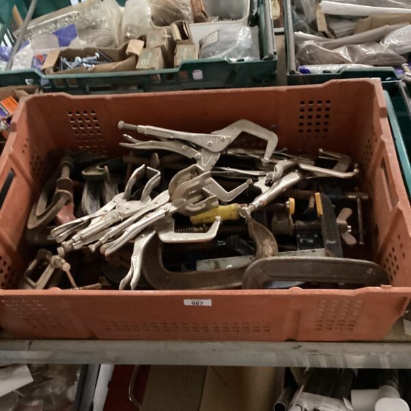 Assorted metal G clamps in a tray, workshop tools.