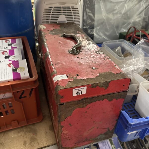 Front view of a weathered vintage metal toolbox.