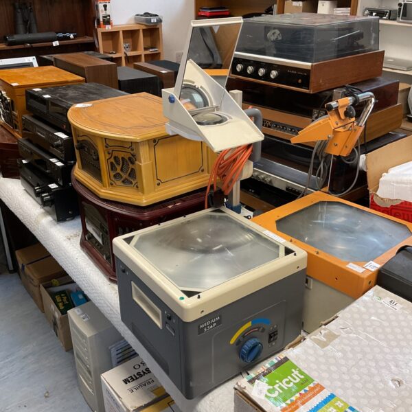 Vintage Medium 536p overhead projector with other items in background.