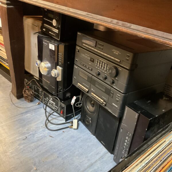 Vintage hi-fi separates stacked on a shelf, including Sony and Panasonic units.