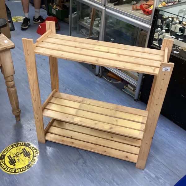 Rustic pine storage unit with three shelves.