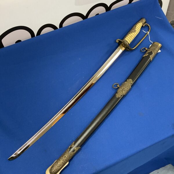 Full view of the Japanese Biden Kuni Yokoyama reproduction sword on a blue surface.