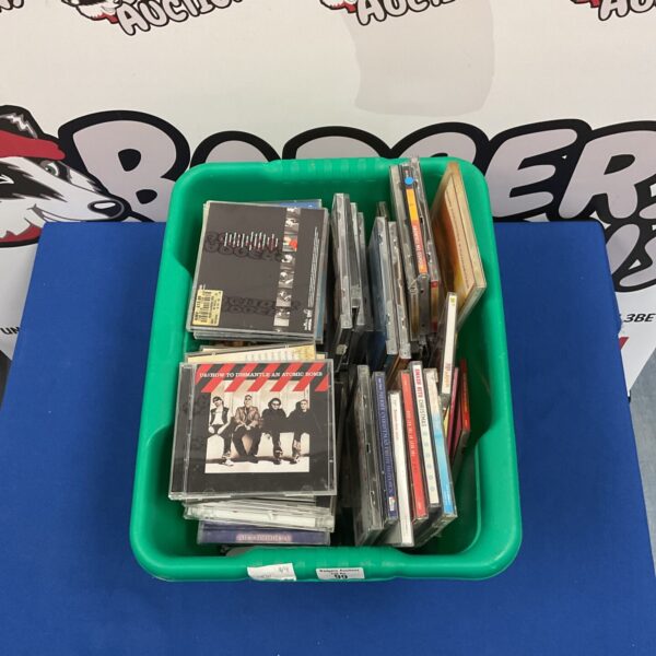 Mixed CD lot in a plastic storage container.